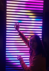 A lady in front of a light display at Stellar - Festival of Lights, part of Elemental AKL 2019