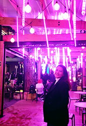 Jhe Valenzuela in front of a purple light display at Stellar - Festival of Lights, part of Elemental AKL 2019