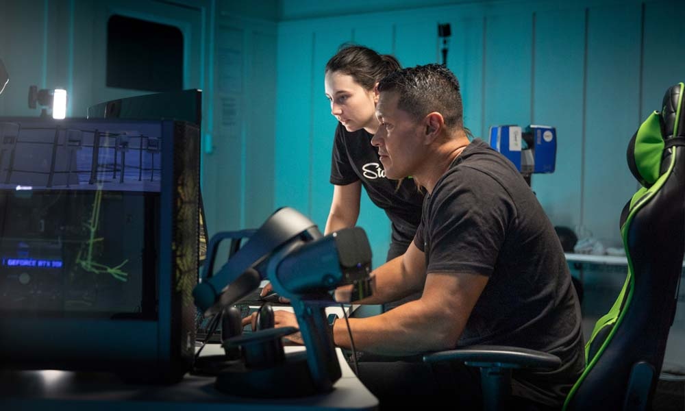 Man and woman looking at a computer