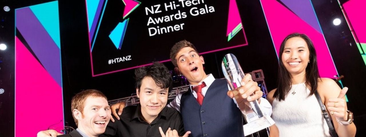 photos of 4 people at NZ Hi-Tech Awards holding trophy