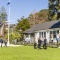 Delegates interact in front of boathouse