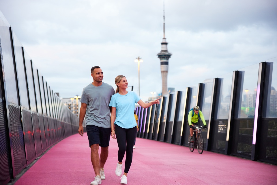 Two people walking along a path in the city