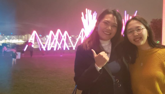 Jhe Valenzuela and Sonia Min in front of a light display at Stellar - Festival of Lights, part of Elemental AKL 2019