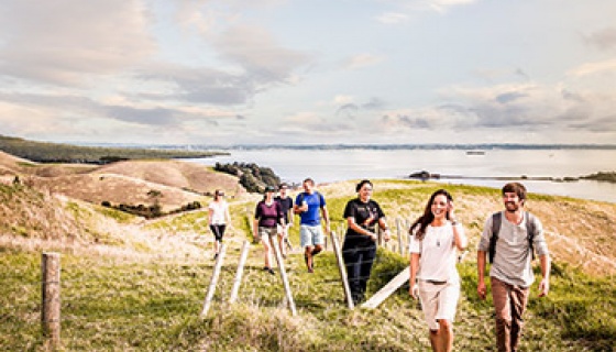 A group of people walking on Auckland's Motutapu Island