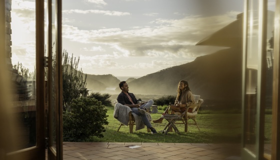 Man and woman at accommodation by the beach.